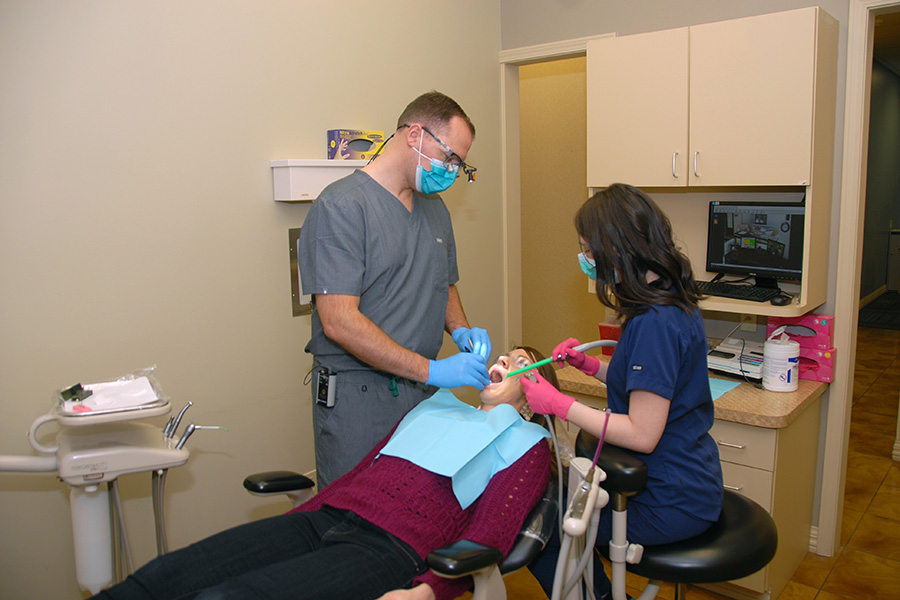 Dr. Miller during a dental checkup with a patient at Raintree Dental