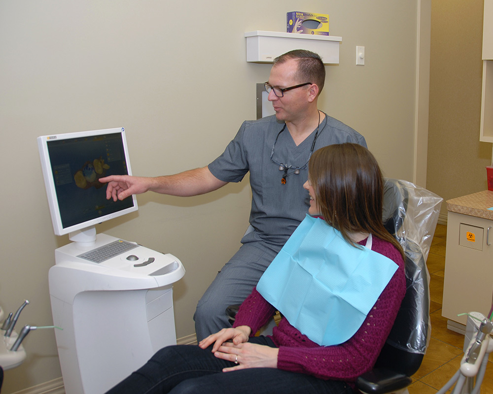 Dr. Miller looking at dental x rays with a patient